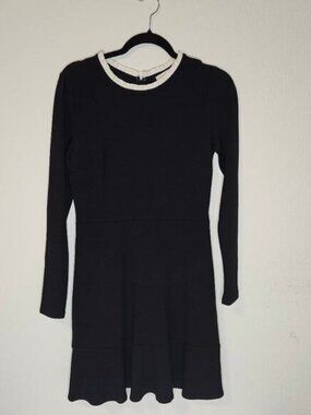 black long sleeve zip up back with white ruffle neck-line